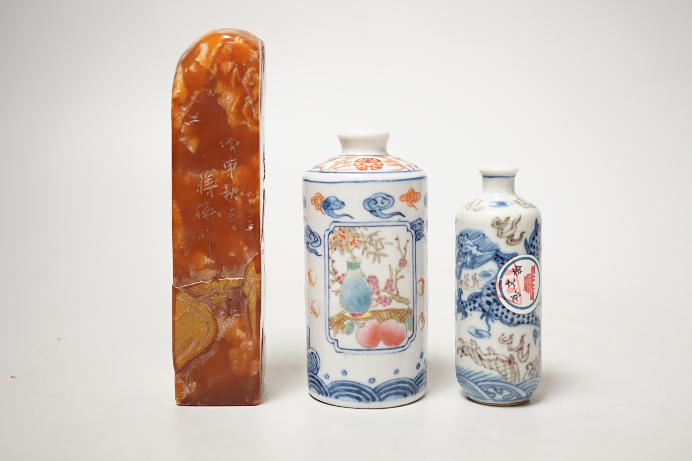 Two Chinese porcelain snuff bottles and a Chinese soapstone seal, 12.7cm